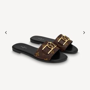 LOUIS VUITTON lock it flat mules.